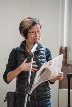 Kazuko Hohki, with hand on heart, speaks into microphone